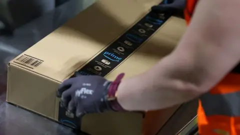 Getty Images Man packing in Amazon box