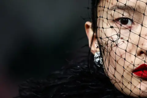 HENRY NICHOLLS/AFP Models present creations by British designer Richard Quinn during the catwalk presentation for his Autumn/Winter 2024 collection during London Fashion Week in London on February 17, 2024.