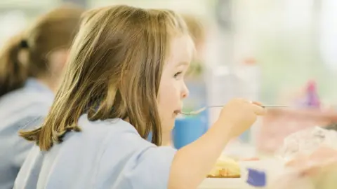 Getty Images Girl eating school lunch