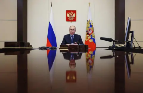 Getty Images President Putin chairs a meeting via a video link at the Novo-Ogaryovo state residence outside Moscow in April