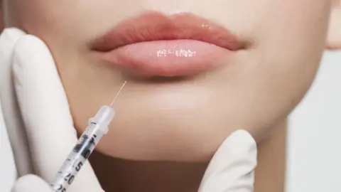 Getty Images Botox being injected in a woman's lip