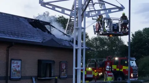Bedfordshire Fire Service An aerial platform was used to tackle the fire, which partially destroyed the building's roof