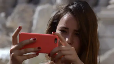 Getty Images Young woman takes a selfie