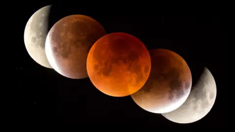 SPL The Moon appears red in a lunar eclipse as sunlight is filtered through Earth's atmosphere (c) SPL