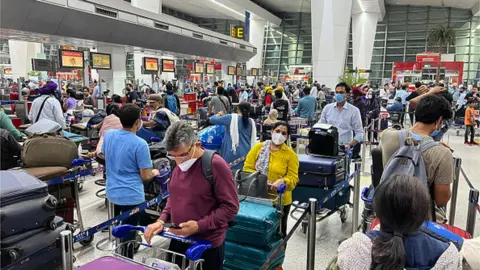 Getty Images Passengers at Delhi airport