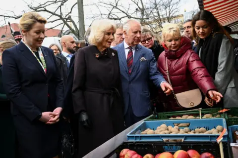 Reuters Berlin's Mayor Franziska Giffey, King Charles and Camilla, the Queen Consort, visit a farmer's market on Wittenbergplatz, a public square in Berlin