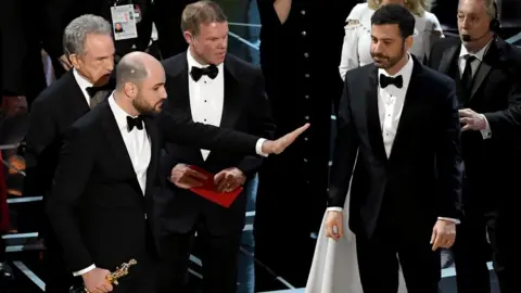 Getty Images Warren Beatty, La La Land producer Jordan Horowitz and Jimmy Kimmel on stage at the Oscars