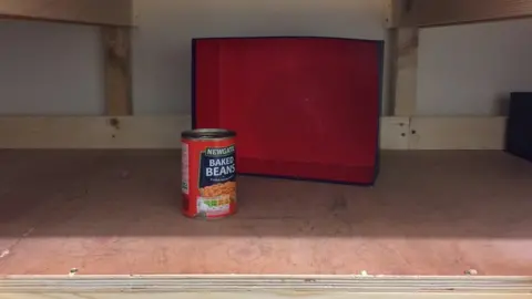 Eastside Food Bank A shelf with just one tin of beans