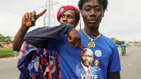 Reuters Supporters of the leader of Liberia's ruling party Coalition for Democratic Change (CDC), President and former soccer player George Weah, react as they arrive to his final campaign rally for the presidential elections in Monrovia, Liberia October 8, 2023