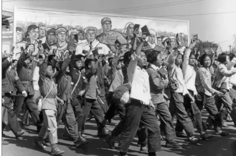 AFP School and university Red Guards, waving copies of Chairman Mao's "Little Red Book", in a June 1966 parade in Beijing