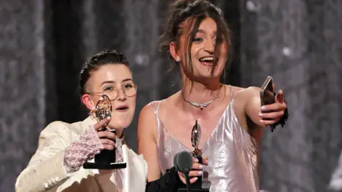 Theo Wargo Lucy Moss (left) and Toby Marlow accepting their Tony Award for best score for Six: The Musical