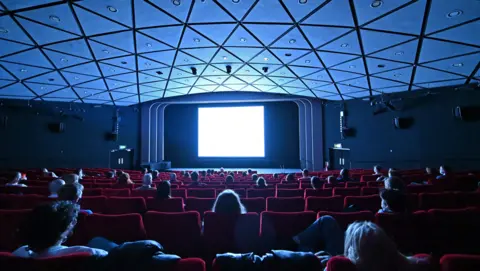 AFP Cinema-goers watch Ingmar Bergman's "Persona" in the BFI Southbank cinema in London on 17 May 2021.