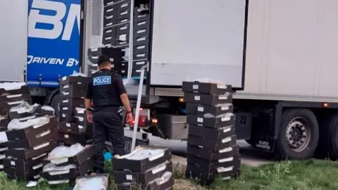 Cambridgeshire Police Police officer with lorry and boxes of grapes