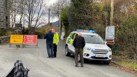 A police car near the village of Garreg and a road closed sign