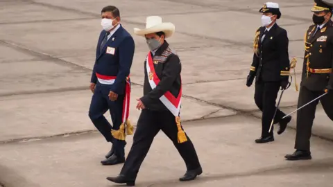 Getty Images Peruvian President Pedro Castillo (white hat) reviewing the troops at military parade commemorating 200th anniversary of Peruvian independence.