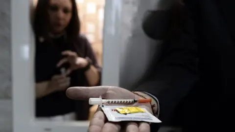 Getty Images A hand holding drugs