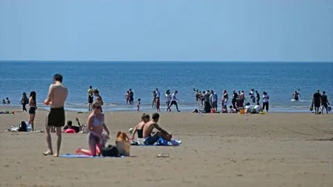 AFP/Getty Images People sunbathing on Blackpool beach