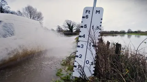Environment Agency Water measurement board on the side of the road