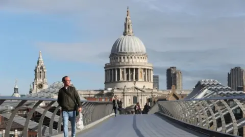 PA Media Commuter crosses a near-empty Millennium Bridge