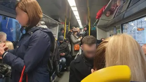 Busy train service where the two metre social distancing rule was unable to be observed by travellers