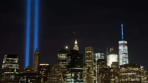 Getty Images The 'Tribute in Light' illuminates the skyline of Lower Manhattan on 11 September, 2016 in New York City.