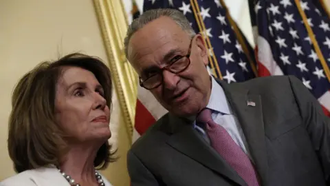 Getty Images Nancy Pelosi and Chuck Schumer talk at the Capitol.
