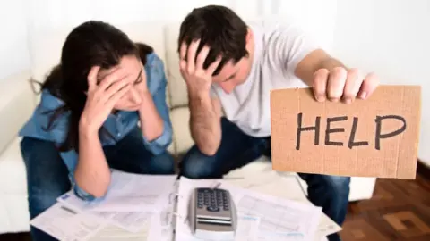 Getty Images Man and woman in financial difficulty