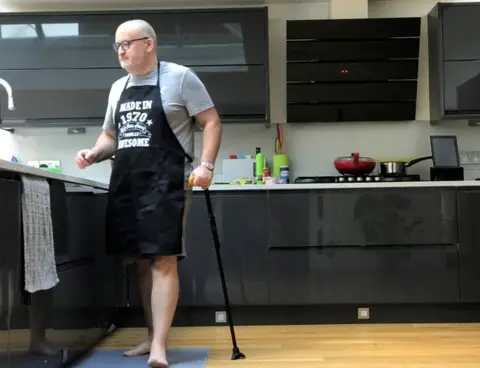 Ian Taverner Ian Taverner standing in his kitchen with his walking stick