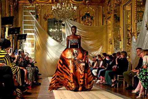 MIGUEL MEDINA / AFP A model wears a creation for Roberto Cavalli's women's spring-summer 2022 collection.