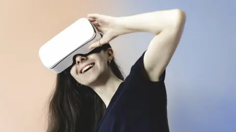 Getty Images A woman wearing VR goggles