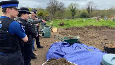 Essex Police Carly Burd showing Essex Police officers the damage caused at Canons Gate allotments