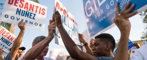 Getty Images Supporters of the Republican and Democratic candidate for Florida governor face off