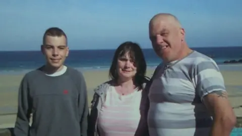 Family Handout Daniel Elton and his parents on a family holiday