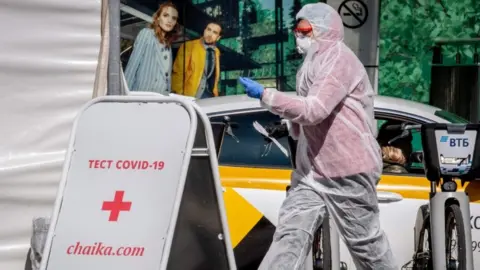 AFP A medical staff walks near a testing point for Covid-19 in central Moscow