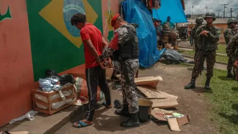 Getty Images A man being arrested in Brazil