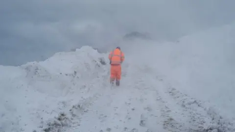 Getty Images A member of Redcar and Cleveland council inspects a blocked road on March 1, 2018 in Liverton Mines, United Kingdom