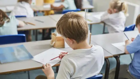 Getty Images Children at school desks