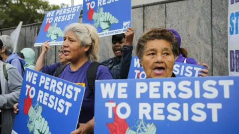 Getty Images Protestors take to the streets after Donald Trump's immigration decision.