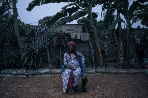Alexis Huguet/AFP Woman sitting on a chair, 29 July 2023