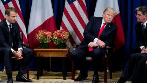 Getty Images Emmanuel Macron, Donald Trump and translator