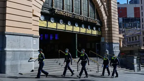 EPA Police patrol outside Flinders Street Station during Melbourne's virus lockdown