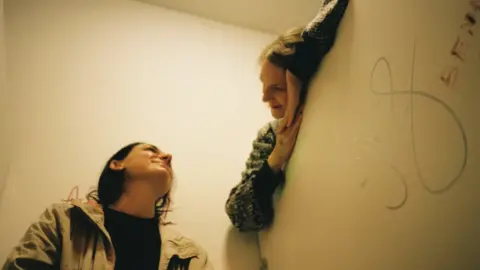 Samantha Jagger Girls looking over cubicle