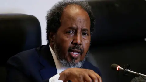 Reuters Somalia's President Hassan Sheikh Mohamud speaking in front of a microphone