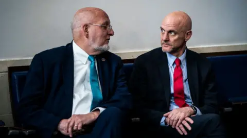 Getty Images Dr Robert Redfield and Stephen Hahn talking to each other on a bench