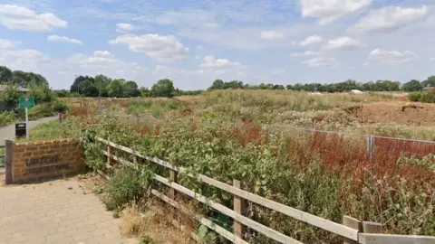 Google Wild grassland with wooden fence and "Upton Country Park" sign