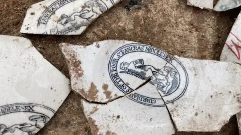 Mola Image showing fragments of white pottery with branded blue and red decoration