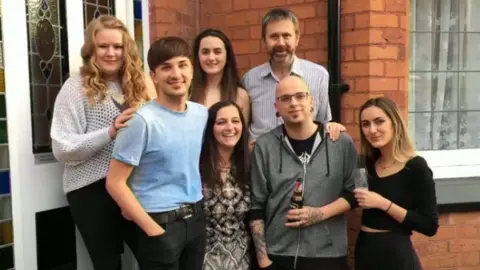 Family handout Martyn Hett with his mum, stepfather and siblings