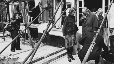 Roy Jenkins at the door of the bombed Horse and Groom, with Commander Bob Huntley behind him