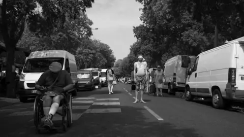 Jack Moyse man standing in street wearing blindfold