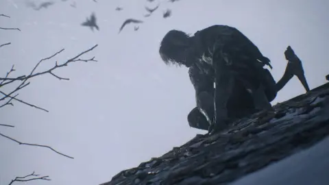 Capcom A misshapen zombie perches on the slate roof of a village building in this screenshot from the upcoming game